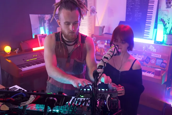 Gray Contrast at his rig with vocalist Zeli at the mic in a purple-lit studio