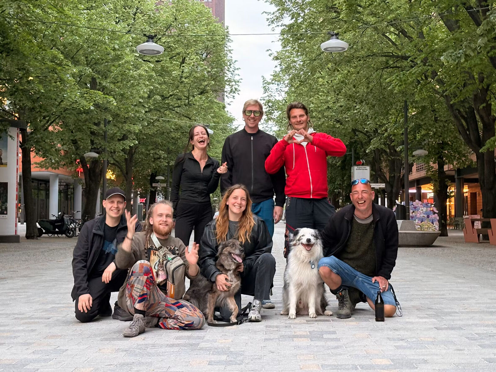 The Mauerpark Love Kommando crew on a Berlin street, with two dogs