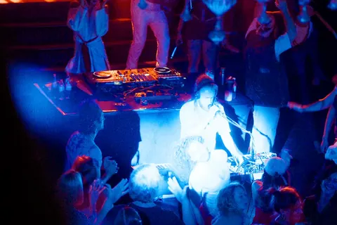 Gray Contrast at the mic behind his keys, seen from above with the crowd around him
